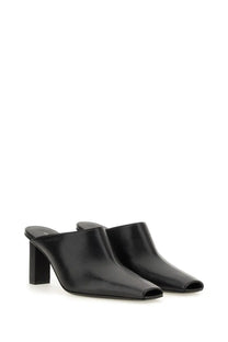 Courrèges women’s sleek black leather mules with square toe and block heel shown from the back side