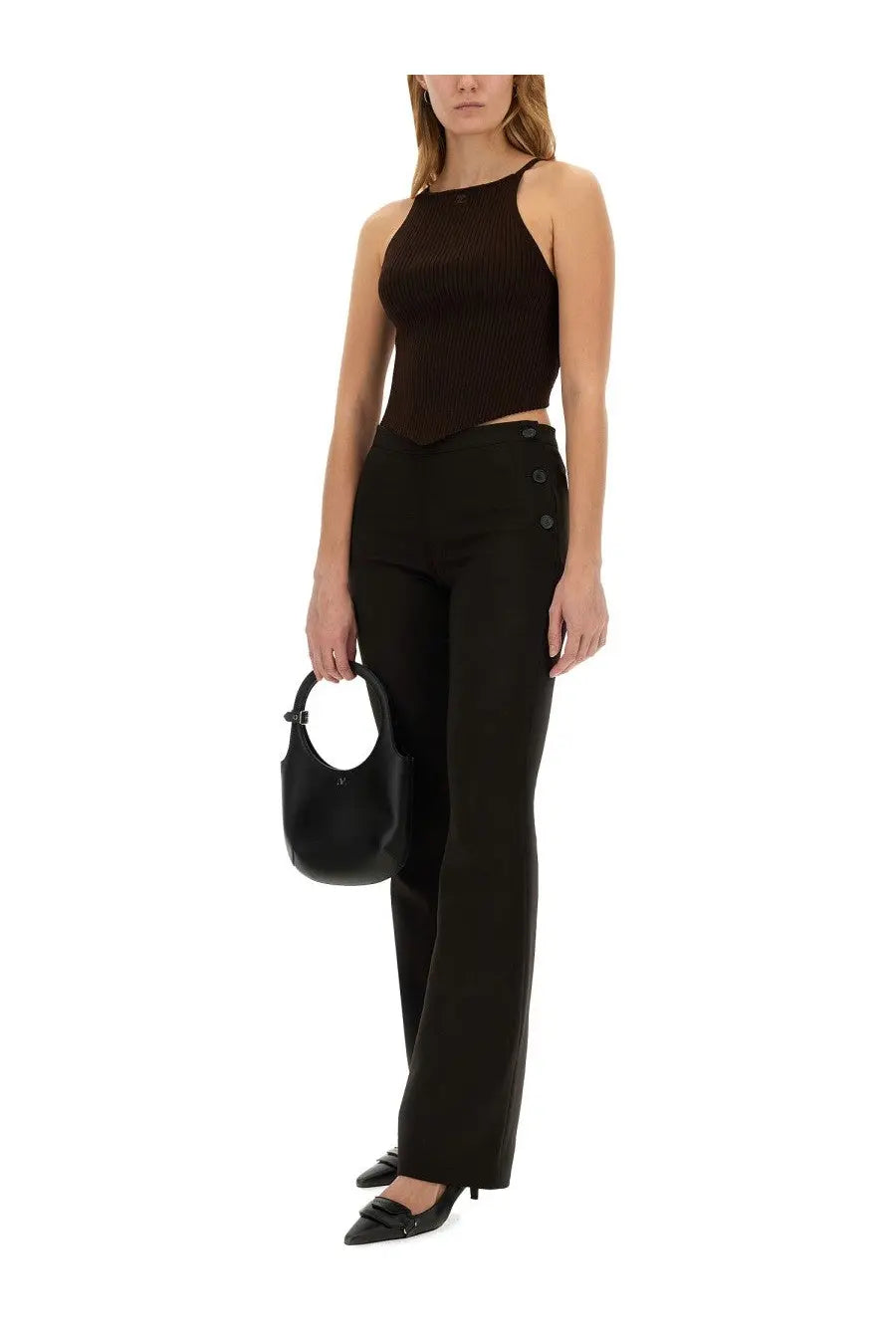 Black leather hobo bag with circular handle and minimalist design paired with courrèges oblique brown tailored pants