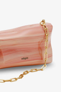 Cult Gaia women’s malaya acrylic clutch in translucent pink and peach marble with gold chain strap and culigala logo embossed