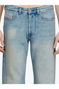 Back view of diesel men’s eeper blue light-wash denim jeans with faded worn look and diesel label on the pocket