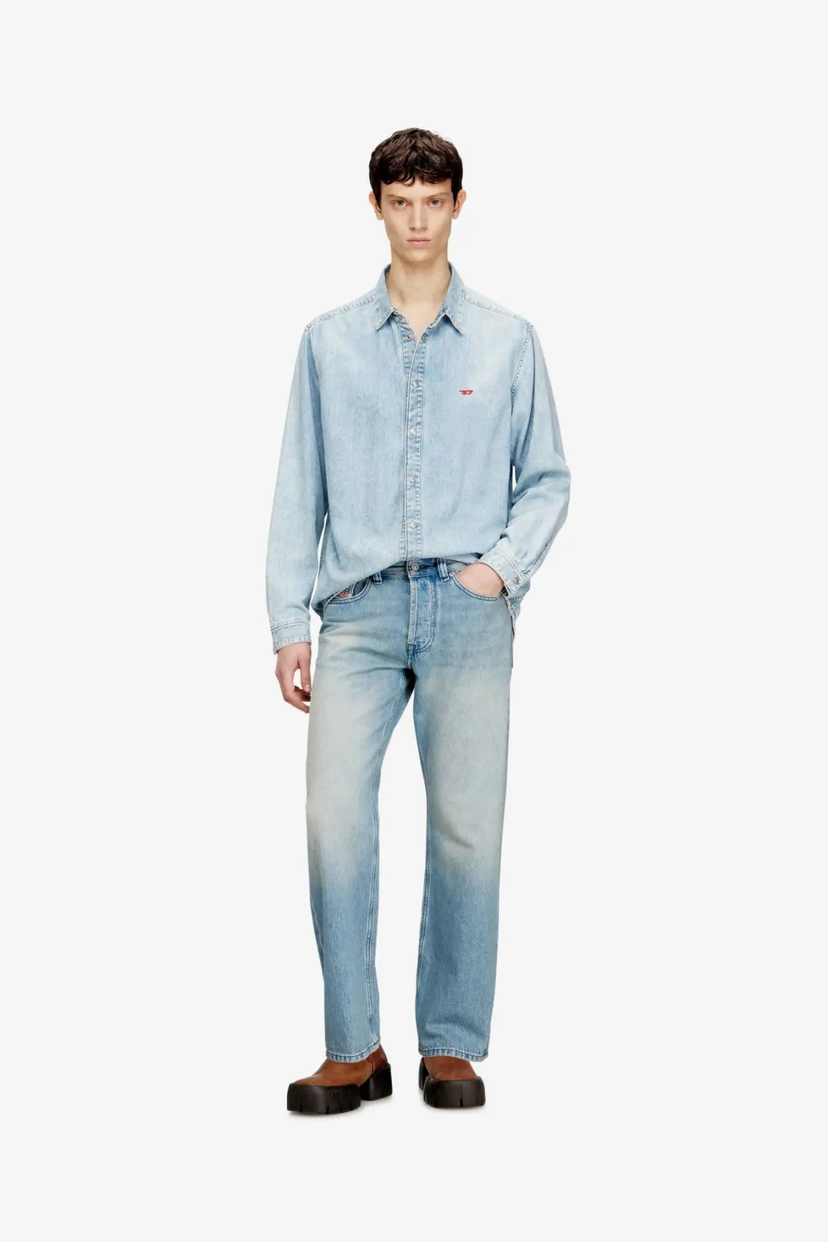 Diesel men’s eeper blue denim jeans paired with a light-wash denim shirt featuring a subtle chest logo