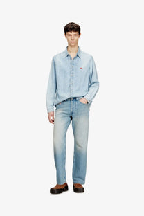 Diesel men’s eeper blue denim jeans paired with a light-wash denim shirt featuring a subtle chest logo