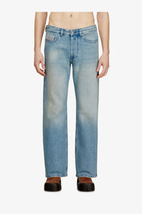 Back side of diesel mens eeper blue light-wash denim jeans with straight-leg cut and subtle fading showing brand logo