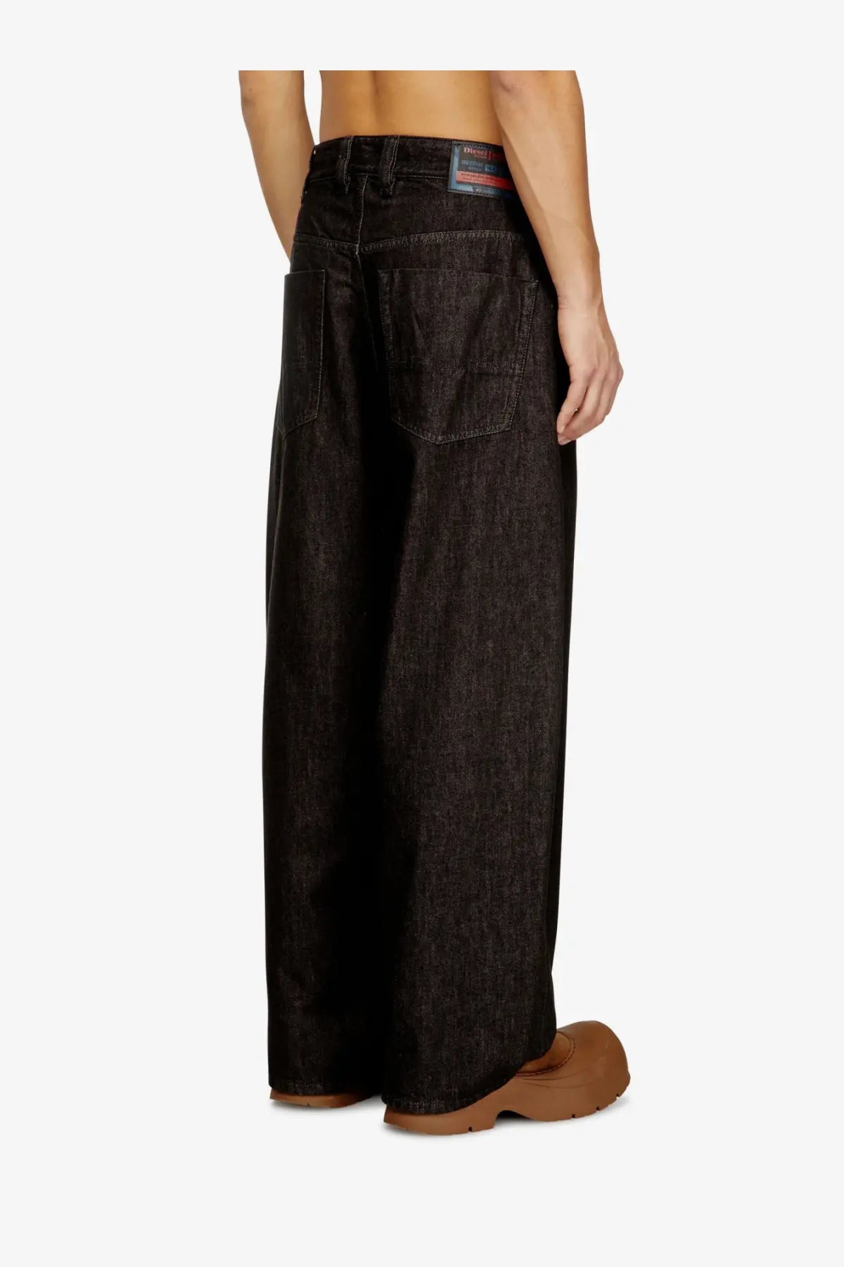 Diesel men’s black wide-leg denim trousers with subtle textured pattern and branded label at the waistband