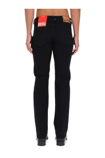 Diesel men’s larkee black jeans showing the back with black denim and a red brand tag on the waistband