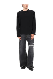 Black long-sleeved crewneck sweater with relaxed fit paired with diesel men’s jeans rise blue for casual wear