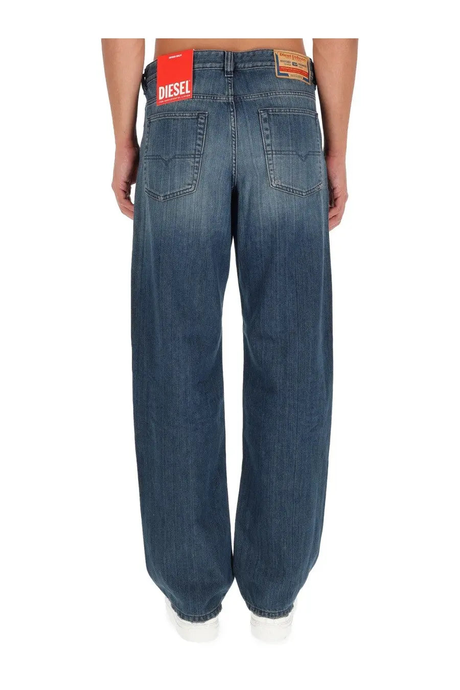 Blue denim diesel men’s macro jeans showing red diesel brand label on waistband