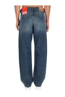 Blue denim diesel men’s macro jeans showing red diesel brand label on waistband