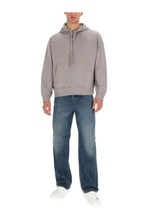 Gray hooded sweatshirt with front pocket and drawstring paired with Diesel men’s blue Macro jeans