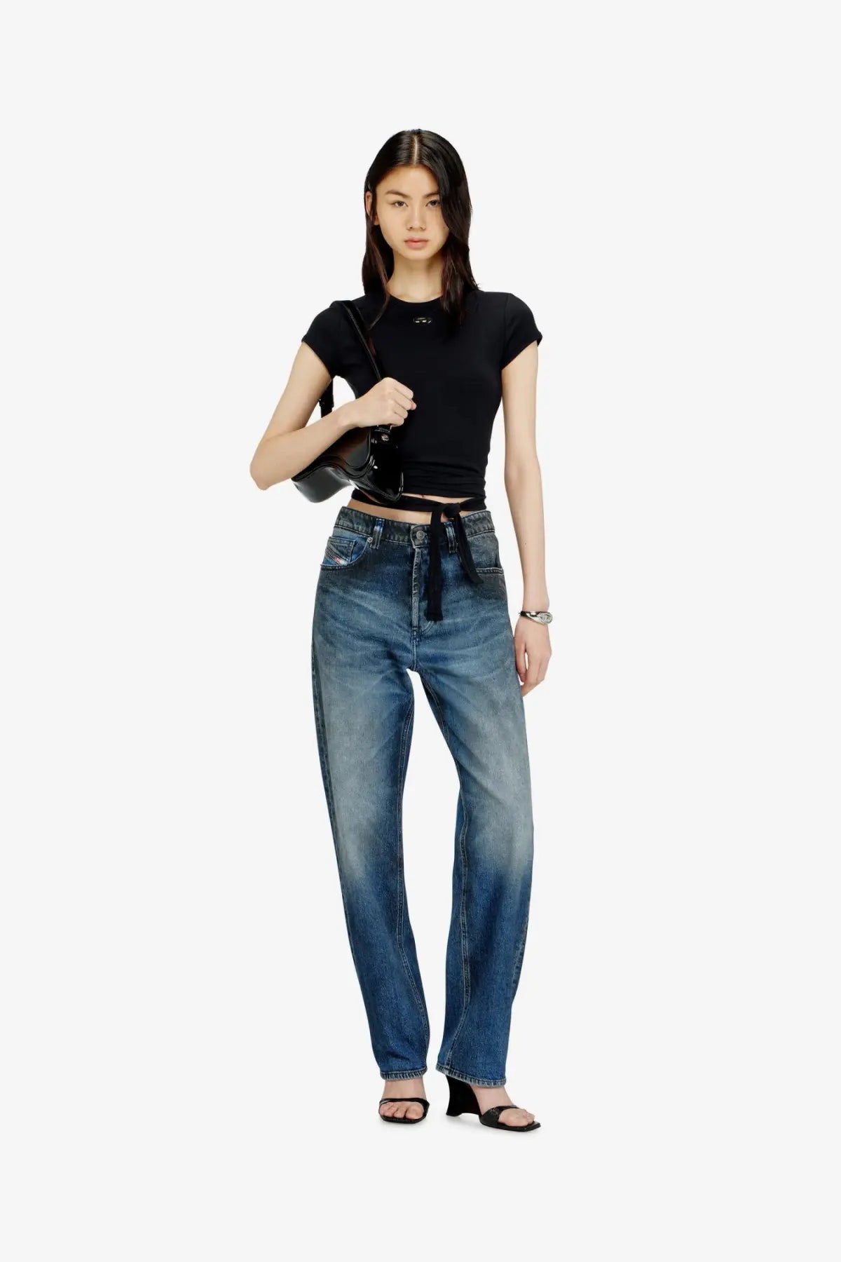 High waisted blue denim jeans with faded wash and straight leg cut paired with diesel womens black cotton shirt