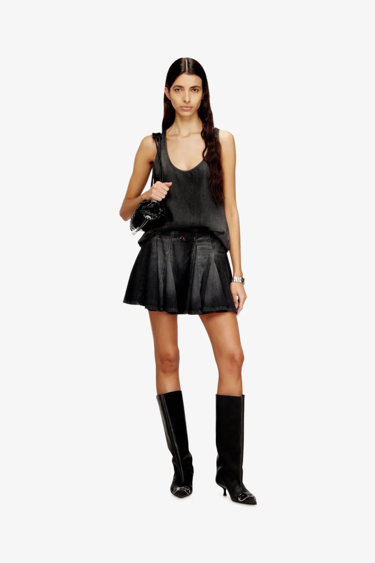 Black pleated mini skirt with sleek glossy finish and subtle stitching details complementing diesel tank top