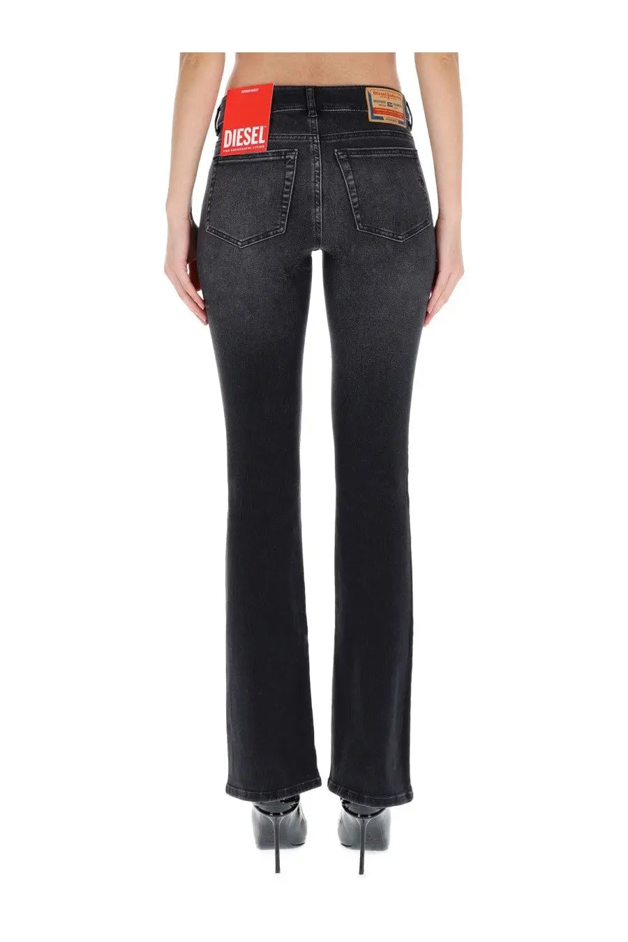 Black denim diesel women’s ebbey jeans with faded wash and red brand label on back waistband shown from back side