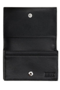 Black leather diesel womens portacarte 1dr silver wallet with silver snap buttons and embossed logo visible