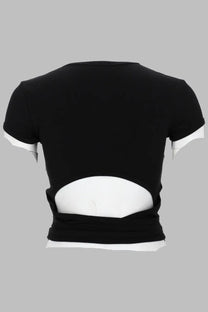 Back view of diesel women’s black cropped costine con lacci shirt with white sleeve trim and lower back cutout revealing inner layer