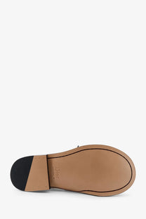 Back view of dior men’s archie leather loafers featuring tan leather sole with black rubber heel and dior branding