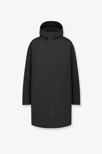 Black hooded Dior men’s couture technical fabric coat with sleek minimalist design and subtle vertical seam detailing