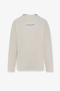 Back view of cream-colored Dior men’s ribbed long-sleeve cotton and wool blend sweater with christian dior branding