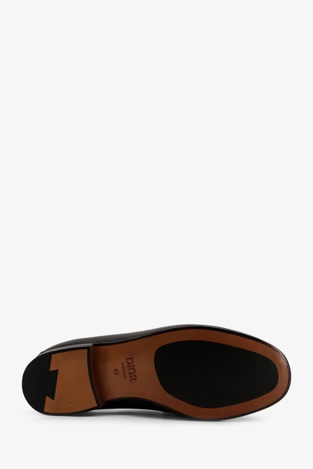 Black leather Dior men’s Granvil loafers with tan rubber sole and size 41 label visible on the back side