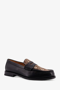 Dior men’s black leather loafers with tan and brown patterned fabric overlay on the toe cap