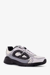 Dior men’s nylon sneakers grey in white and gray with black accents and bold geometric logo on the side