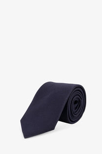 A sleek navy blue silk tie with a subtle textured weave from Dior men’s Dior Ribbon collection
