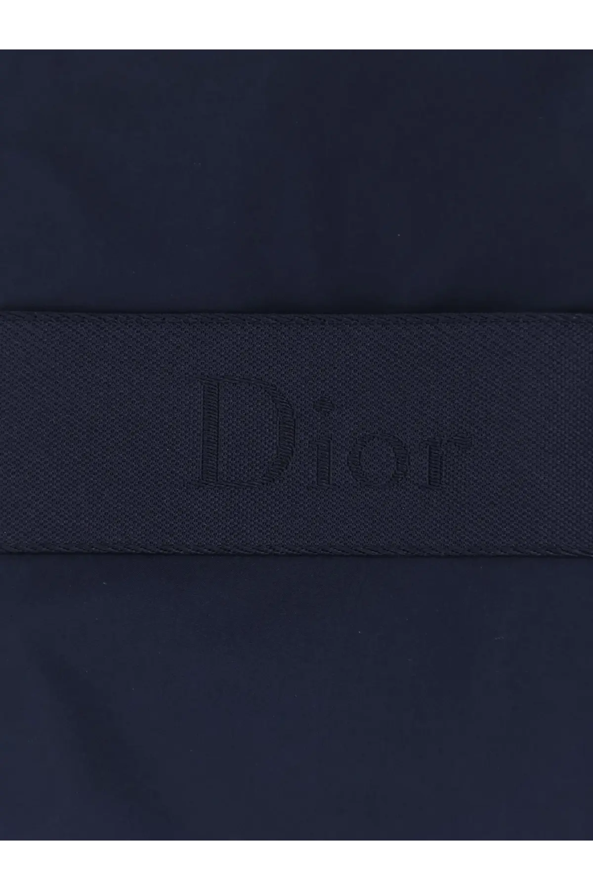 Dark blue dior logo strap with subtle woven texture on dior men’s sleeveless jacket blue back side