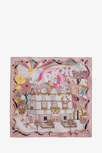 Dior women’s Dior Avenue pink silk foulard featuring a whimsical Parisian building with trees stars and rainbow clouds