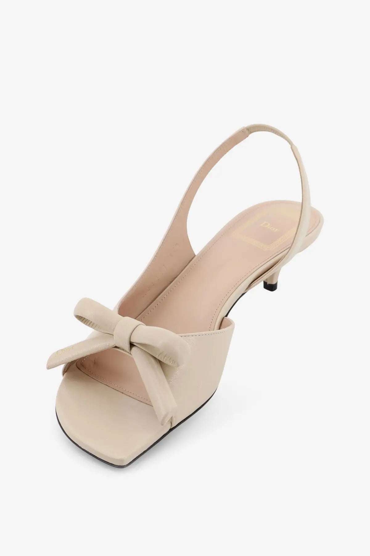 Beige leather Dior women’s slingback sandal with square toe and delicate bow detail at the front