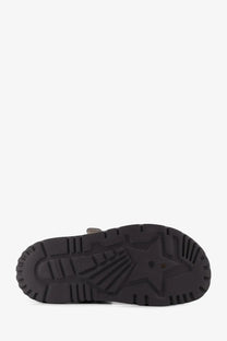 Black rubber sole with star-shaped tread pattern on Dior women’s grey canvas Dioract flat sandals back view