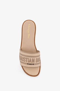Beige canvas Dior women’s dway Dioriviera flat slide sandal with brown leather trim and striped Christian Dior branding