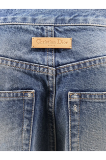Blue denim dior womens flared jeans showing tan leather christian dior paris label at the waistband back side