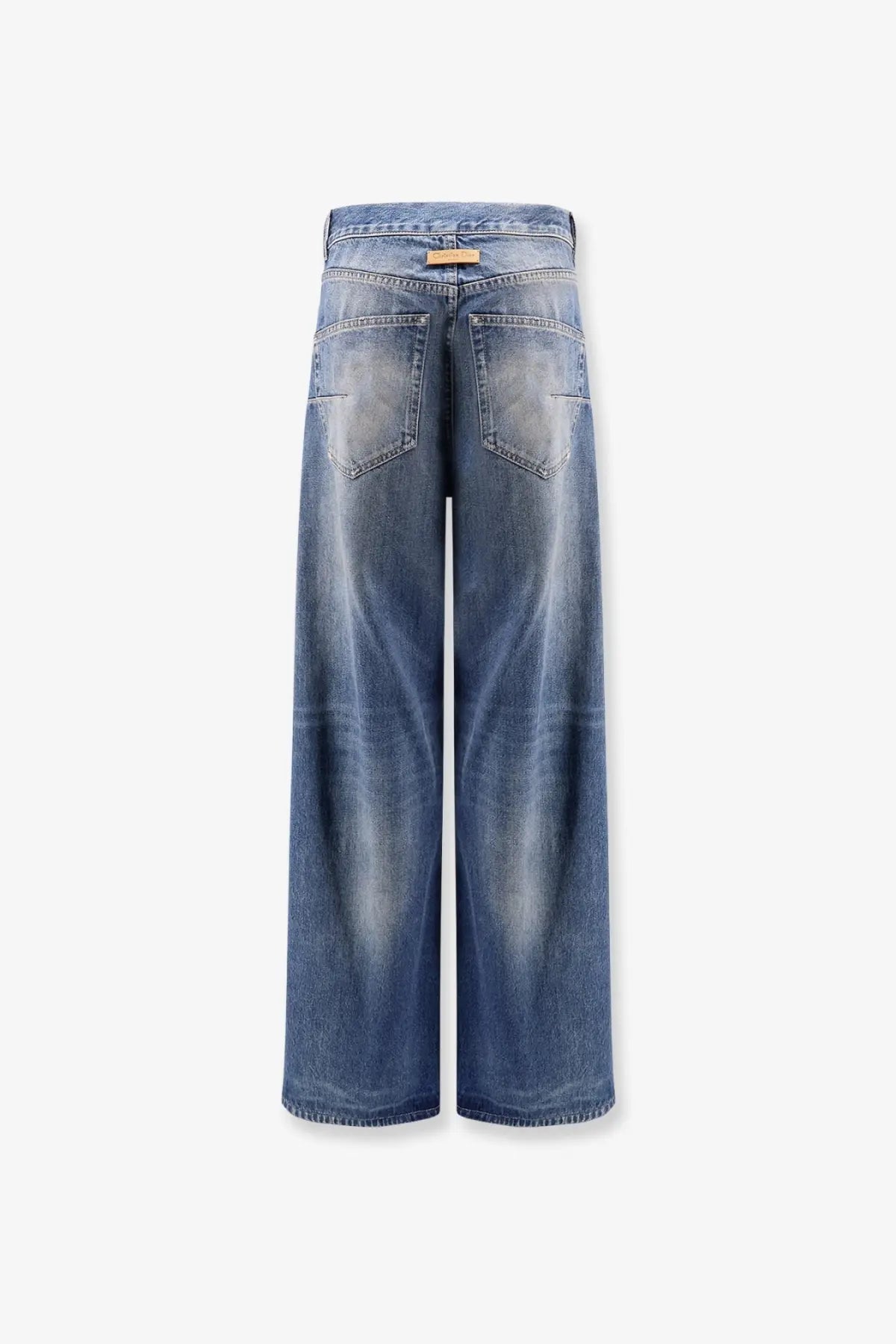 Dior women’s flared jeans in medium blue denim with wide legs, subtle whiskering, and distressed details