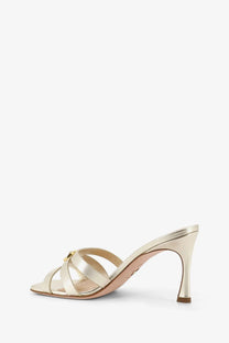 Dior women’s laminated gold leather satin strap mule sandal with slender heel and minimalist design