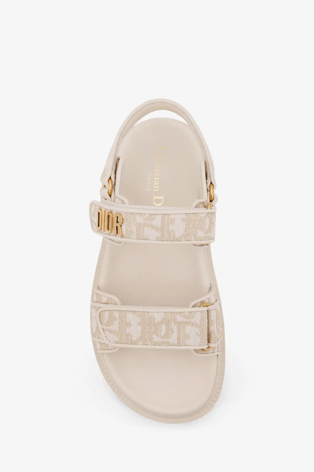 Beige Dior women’s lurex Dioract flat sandal with gold-tone hardware and repeating monogram pattern on straps