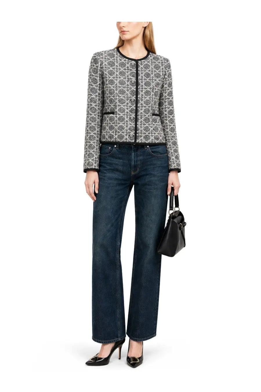 A woman wearing a Dior women’s Macrocannage jacket in grey tweed with black and gray pattern and black trim