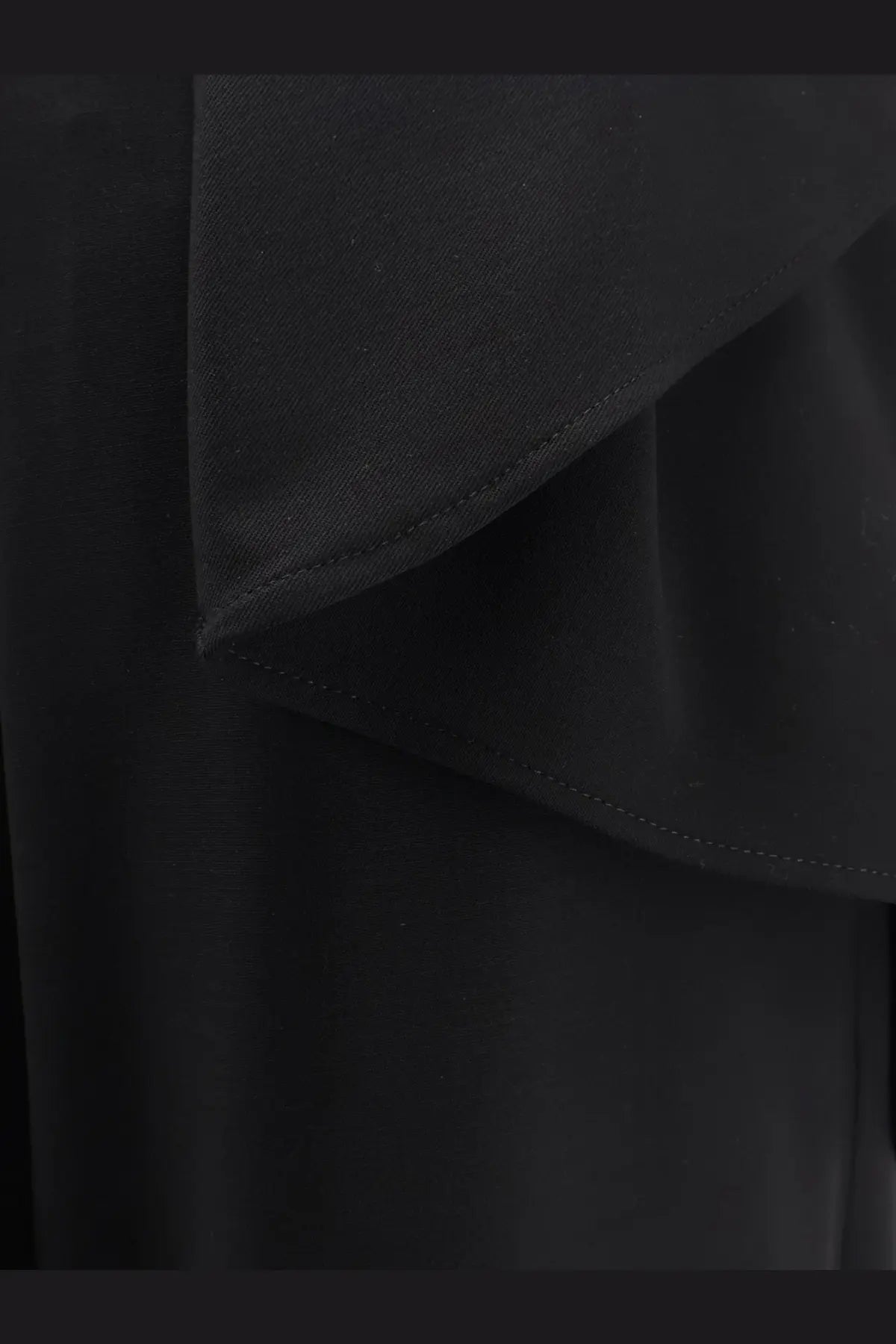 Black ruffled virgin wool fabric with subtle sheen and fine stitching along layered edges on dior womens trousers