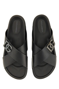 Dolce &amp; Gabbana men’s black calfskin slide sandals with metallic DG logo clasp on the upper strap