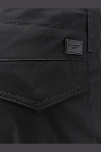 Black dolce and gabbana milano italy label on dark fabric pocket with contrasting stitching of mens cargo stretch cotton trousers