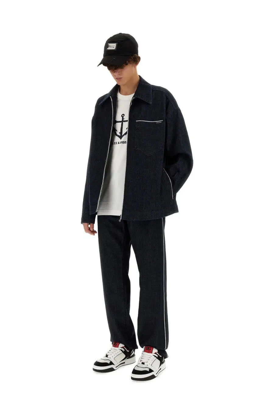 Dolce &amp; gabbana men’s black denim jacket with white stitching and front zipper paired with cimosed blue jeans