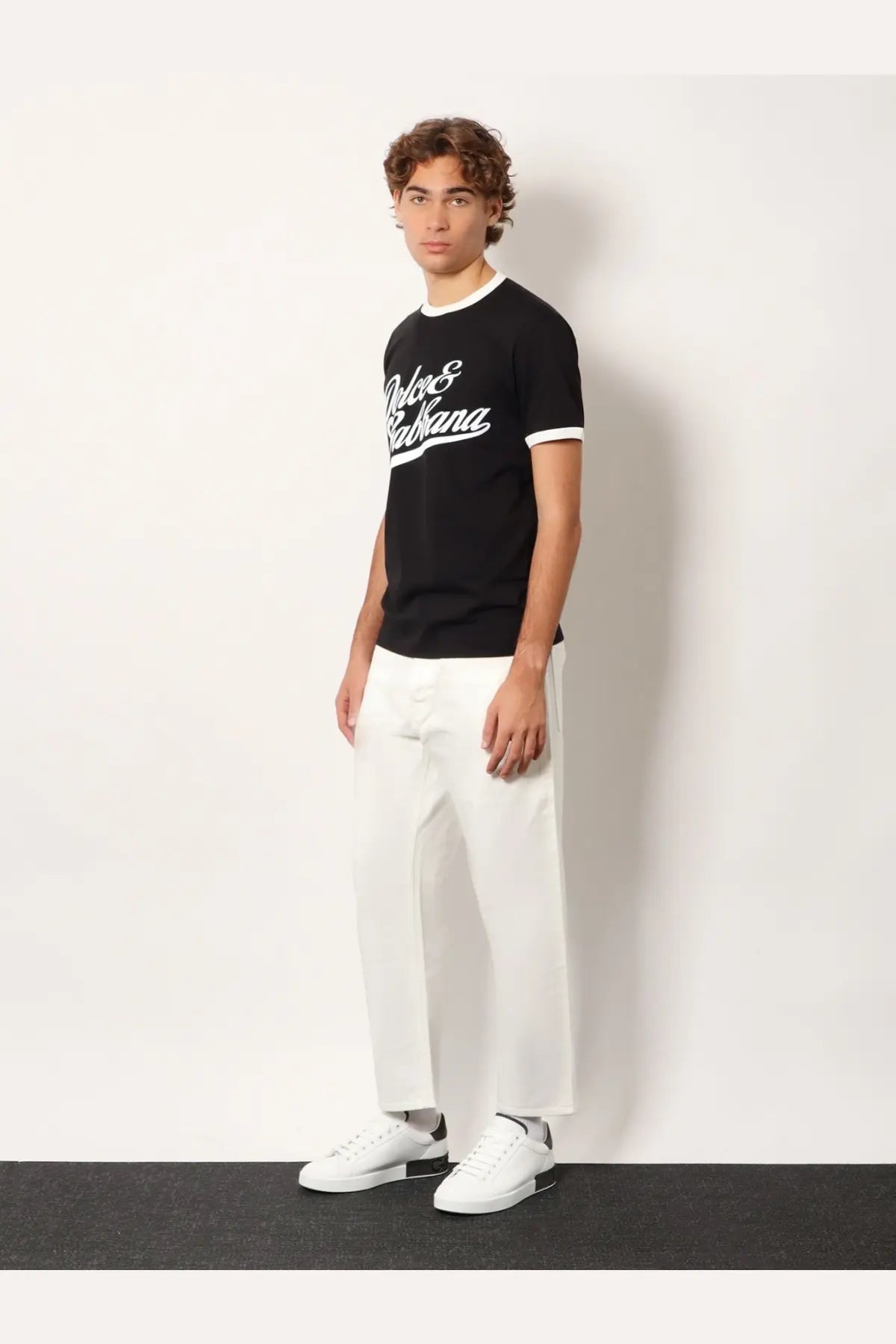 Dolce &amp; Gabbana men’s black cotton t-shirt with white cursive logo and contrasting white trim on collar and sleeve cuffs