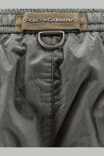 Dolce &amp; Gabbana men’s cotton olive green drawstring shorts with metallic ring and brand label in front view