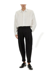 A crisp white long-sleeved button-down shirt with a classic collar paired with dolce &amp; gabbana black double pence pants