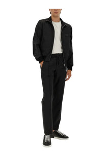 Dolce &amp; Gabbana men’s black bomber jacket with zipper front and subtle chest patch paired with jogging pants