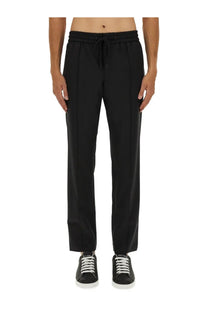 Dolce &amp; Gabbana men’s black drawstring jogging pants with sleek straight-leg cut and subtle front pleats
