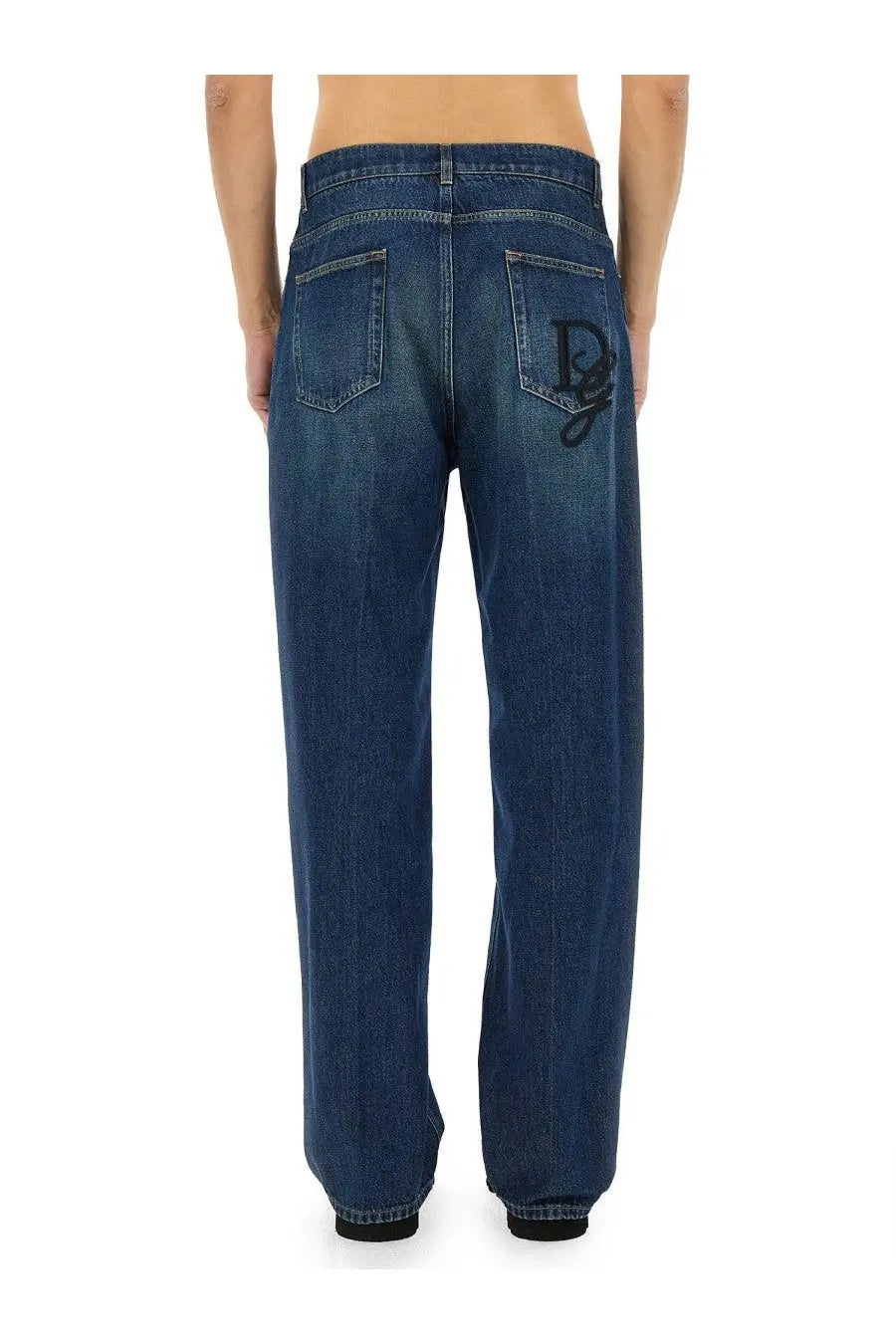 Dark blue denim dolce &amp; gabbana men’s oversize jeans back side featuring a prominent black embroidered logo on pocket