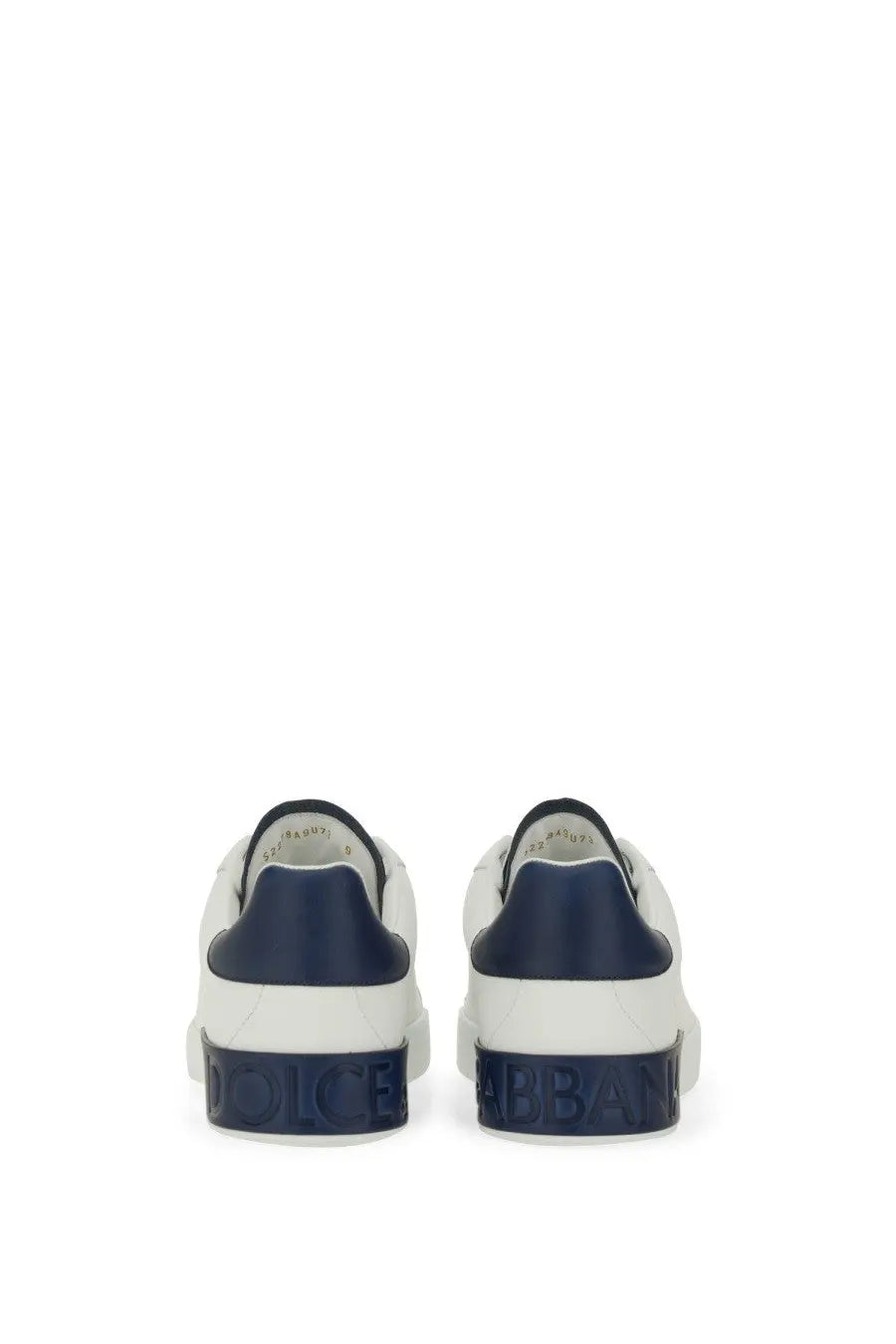 Dolce &amp; Gabbana men’s Portfino sneaker white showing back side with white and navy blue leather and embossed branding on heel