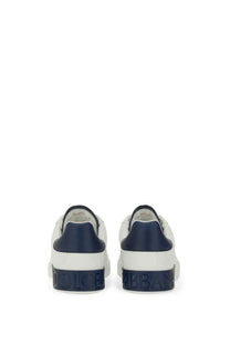 Dolce &amp; Gabbana men’s Portfino sneaker white showing back side with white and navy blue leather and embossed branding on heel