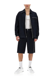 Dark blue denim jacket with zipper front and contrast stitching paired with dolce &amp; gabbana men’s white ribbed tank top