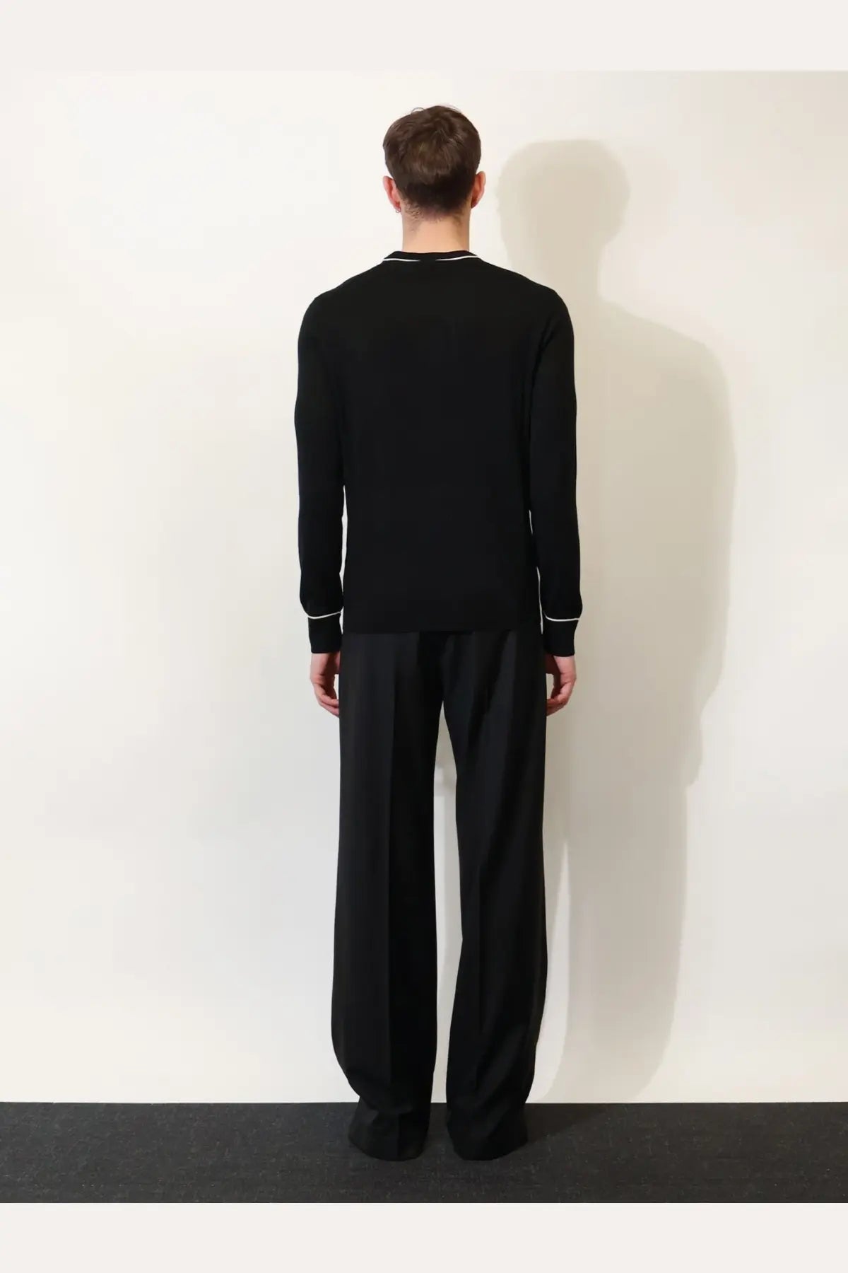 Dolce &amp; Gabbana men’s black virgin wool sweater with subtle white trim along neckline and cuffs