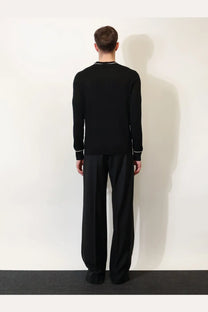 Dolce &amp; Gabbana men’s black virgin wool sweater with subtle white trim along neckline and cuffs